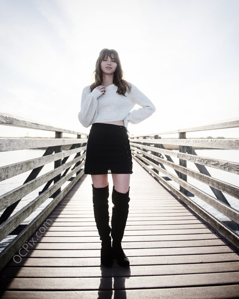 Model in black skirt on wooden bridge