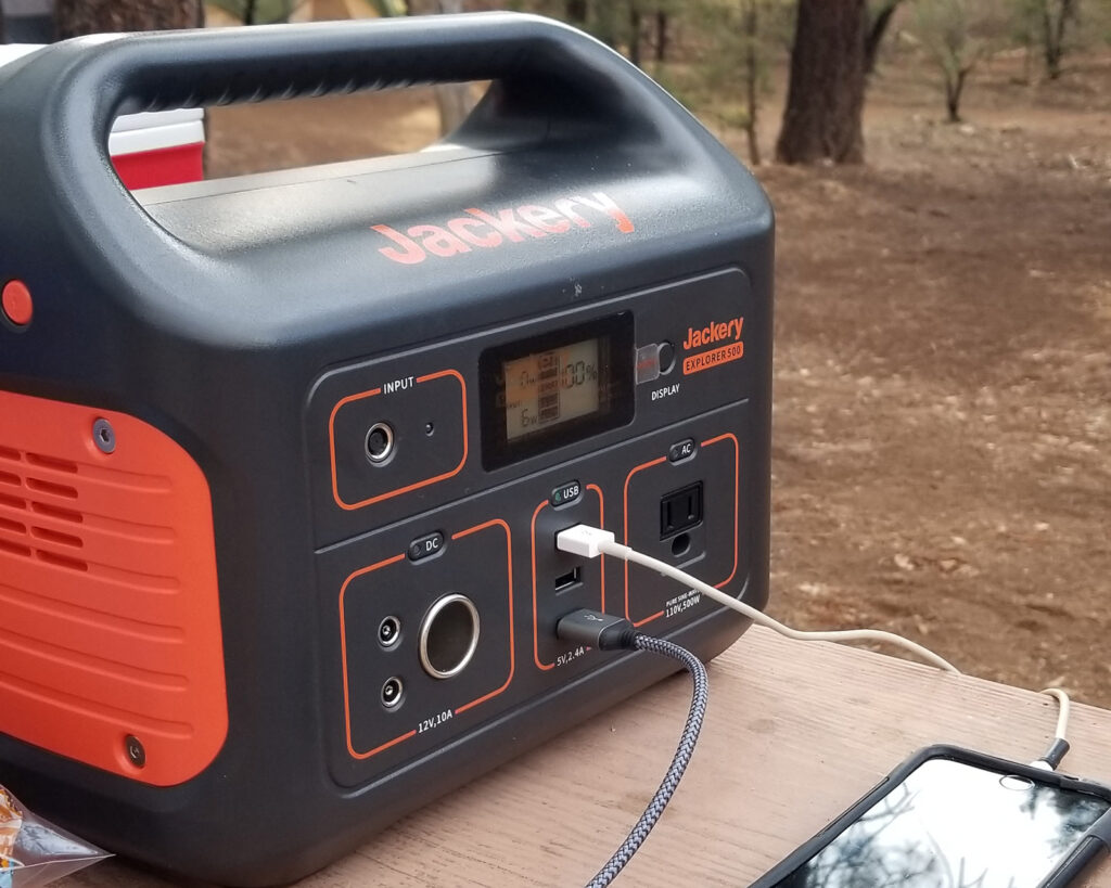 Jackery 500 battery being used outdoors to charge electronics