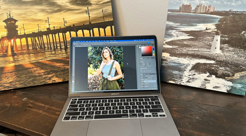 best laptop for photo video editing - MacBook Pro laptop on a table with photos